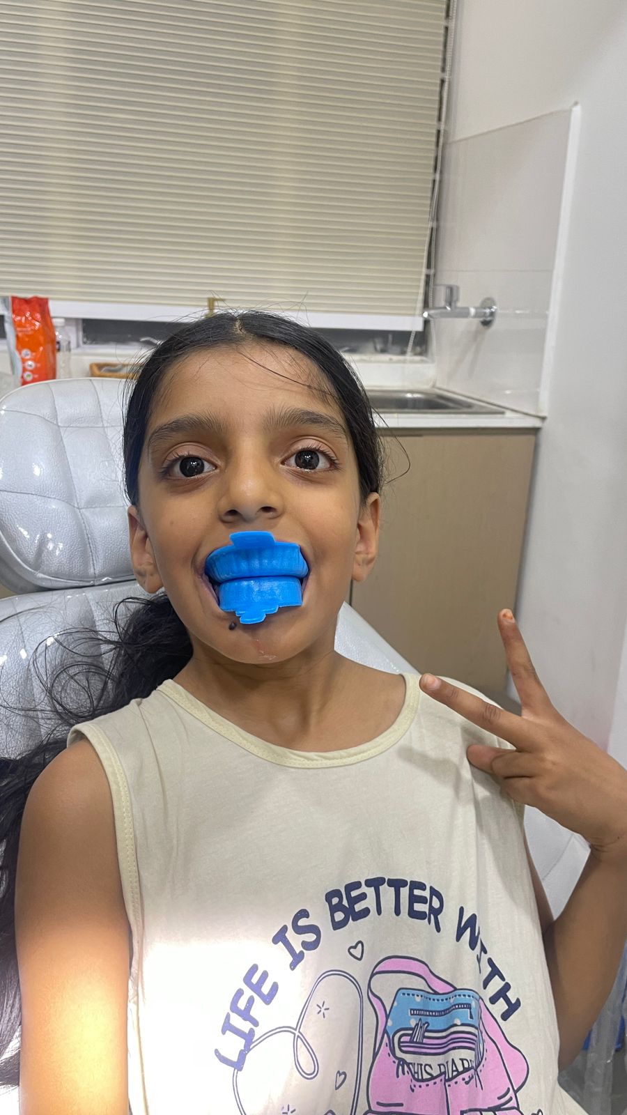 Child wearing a fluoride tray during treatment